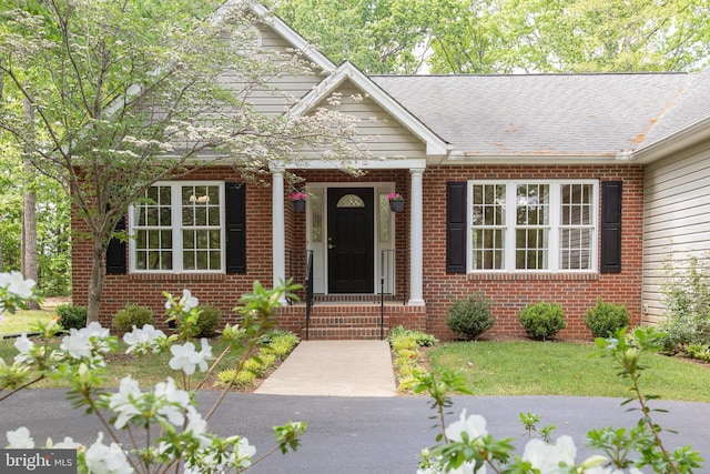 doorway to property with brick siding