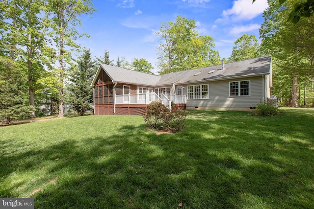 back of house featuring a lawn, a sunroom, and crawl space