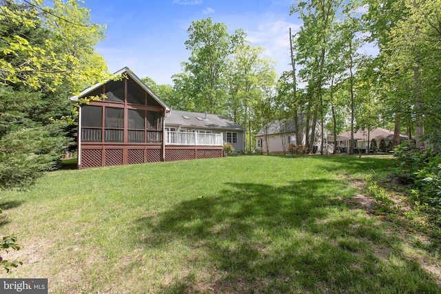 view of yard with a wooden deck and a sunroom