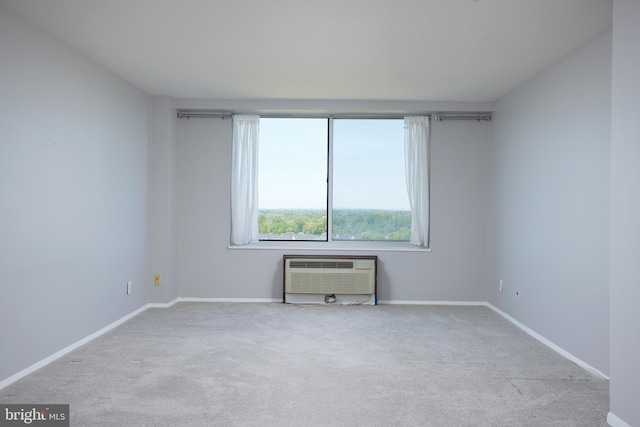 unfurnished room featuring baseboards, carpet, and a wall unit AC