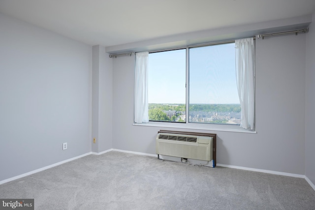 unfurnished room featuring baseboards, carpet, and a wall unit AC