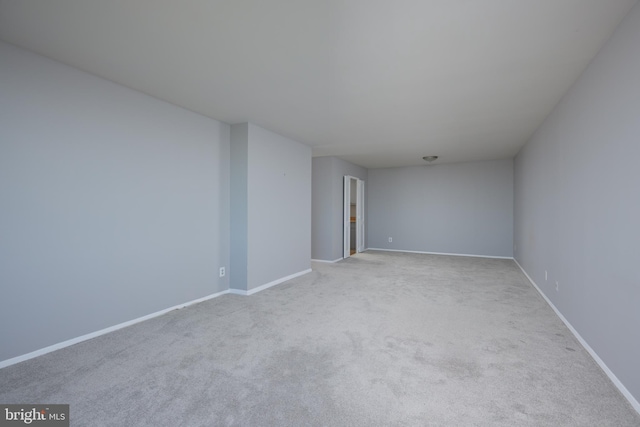 carpeted empty room with baseboards