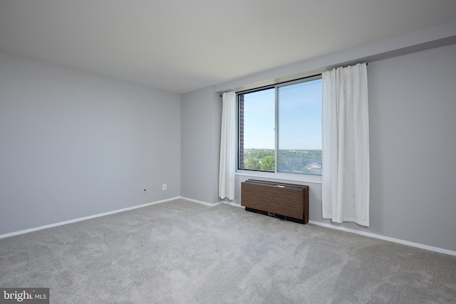 empty room featuring carpet floors and baseboards