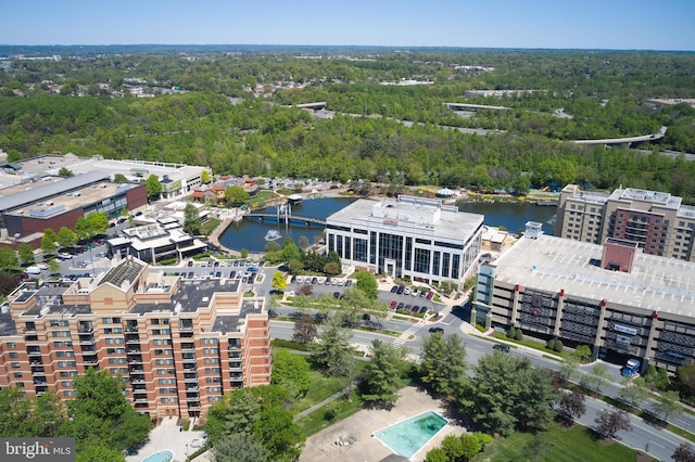 drone / aerial view with a water view and a wooded view