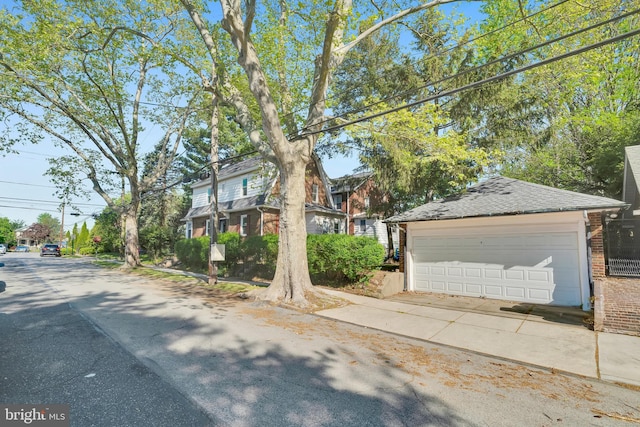 obstructed view of property with brick siding and a garage