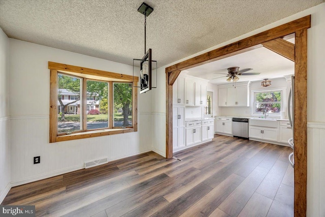 9 Biscayne Blvd, West Deptford, NJ 08096 - unfurnished dining area featuring a wainscoted wall, plenty of natural light, dark wood-type flooring, and visible vents