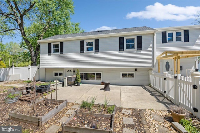 9 Biscayne Blvd, West Deptford, NJ 08096 - back of property featuring a fenced backyard, a gate, a patio, and a garden