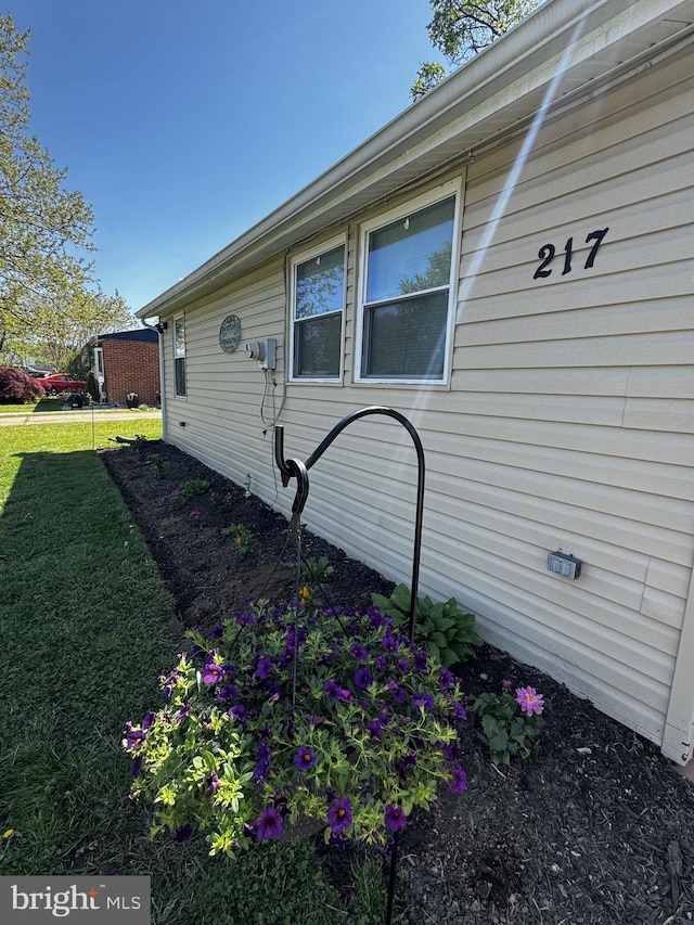view of home's exterior with a yard