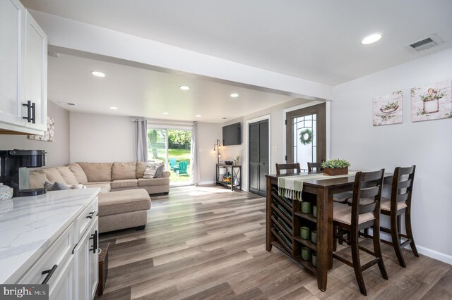 living area featuring visible vents, recessed lighting, and light wood-style flooring