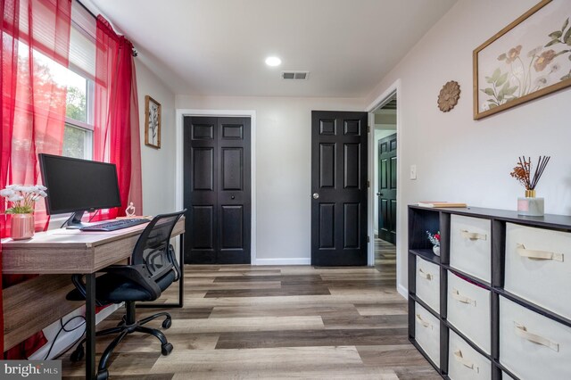 office featuring visible vents, recessed lighting, baseboards, and wood finished floors