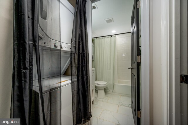 full bath featuring visible vents, marble finish floor, toilet, recessed lighting, and stacked washer / drying machine