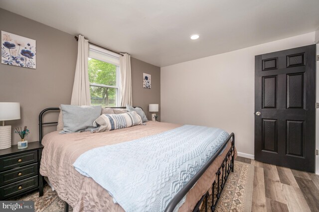 bedroom with recessed lighting, baseboards, and wood finished floors