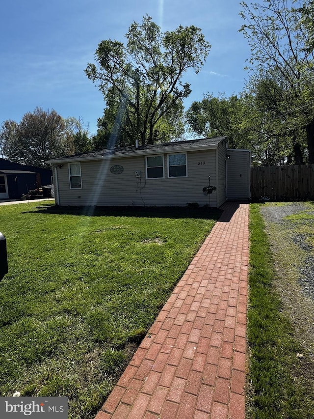 view of front of home with fence and a front yard