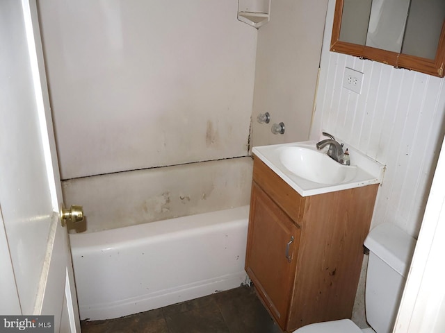 bathroom with vanity, a tub, and toilet