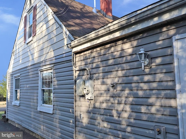 view of side of home featuring a shingled roof