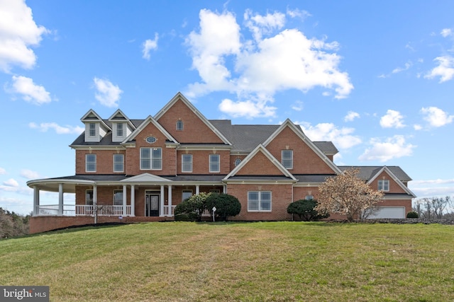 view of front facade featuring brick siding, a porch, and a front yard