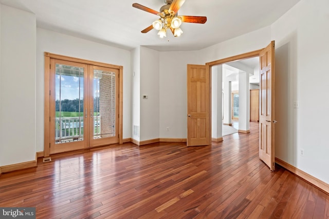 empty room with hardwood / wood-style floors, a ceiling fan, and baseboards