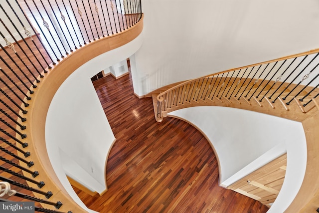 staircase with wood finished floors and baseboards