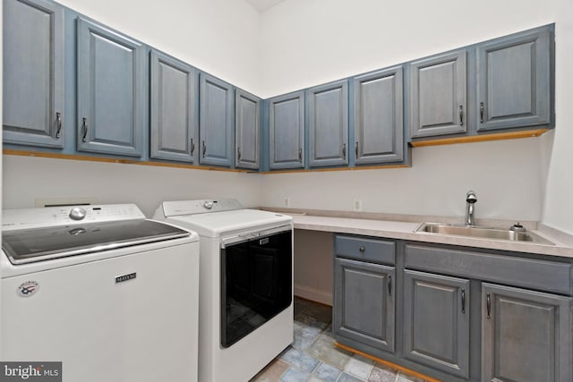 washroom with separate washer and dryer and cabinet space