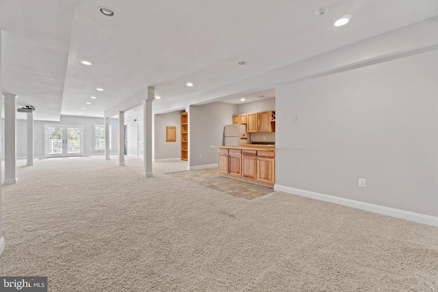 unfurnished living room with light colored carpet, recessed lighting, and baseboards