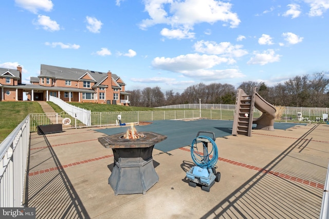 view of pool featuring a fire pit and a patio area