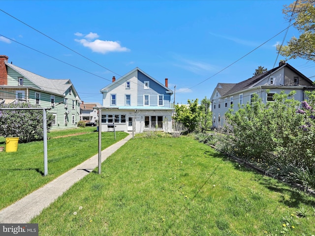 back of house with a yard
