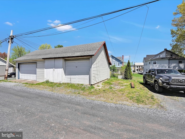 detached garage featuring a residential view