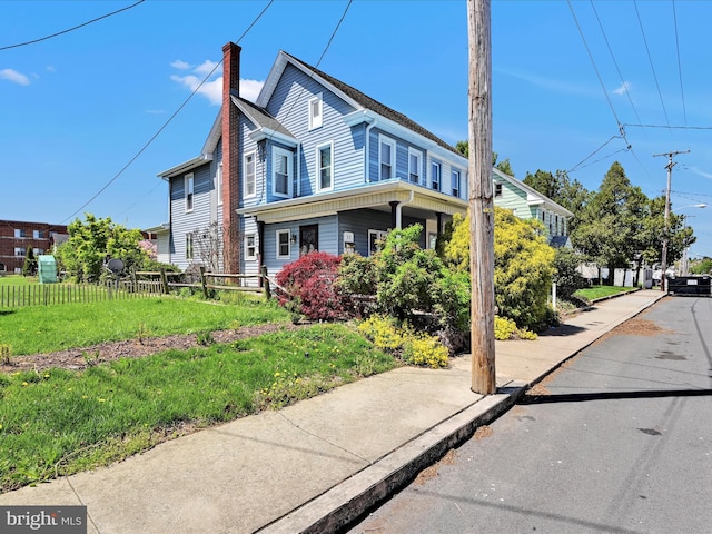 view of front of house with fence and a chimney