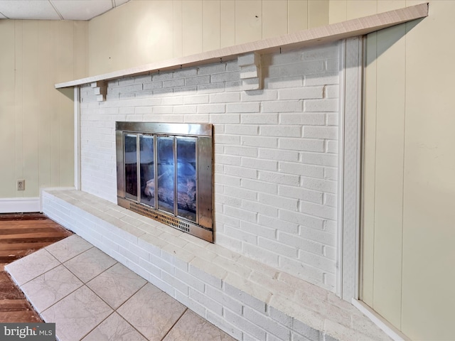 interior details with wood finished floors and a fireplace