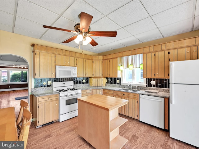 kitchen featuring ceiling fan, a sink, light wood finished floors, wood counters, and white appliances