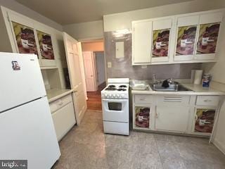 2702 30th St SE Unit A250, Washington, DC 20020 - kitchen with white appliances, white cabinets, a sink, and light countertops