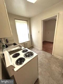 kitchen featuring white electric stove