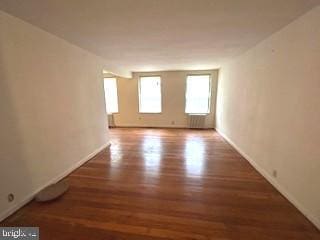 empty room featuring baseboards and wood finished floors