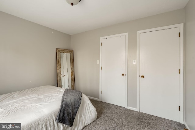 bedroom featuring carpet floors and baseboards