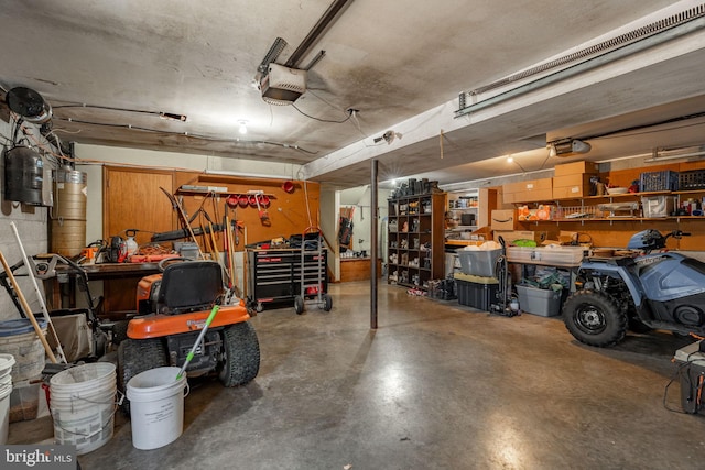 garage with a garage door opener and a workshop area