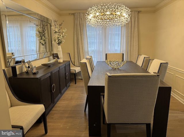 dining space featuring plenty of natural light, ornamental molding, wood finished floors, and a notable chandelier