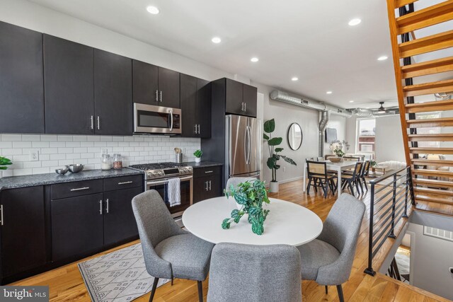 1211 Annin St, Philadelphia, PA 19147 - kitchen with dark cabinetry, ceiling fan, dark countertops, stainless steel appliances, and tasteful backsplash