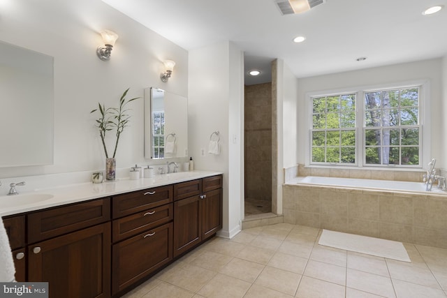 bathroom with a sink, tile patterned flooring, a bath, and visible vents