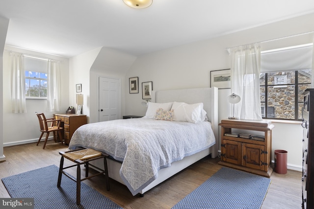 bedroom featuring baseboards and wood finished floors