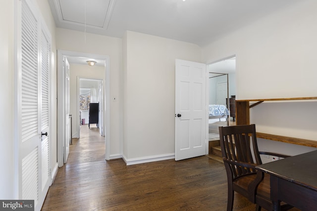office area featuring baseboards, attic access, and dark wood-type flooring