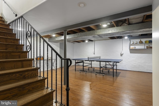 finished below grade area with wood finished floors and stairway
