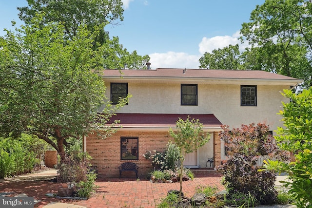 4 Virginia Rd, Glassboro, NJ 08028 - view of front facade with stucco siding, a patio, and brick siding