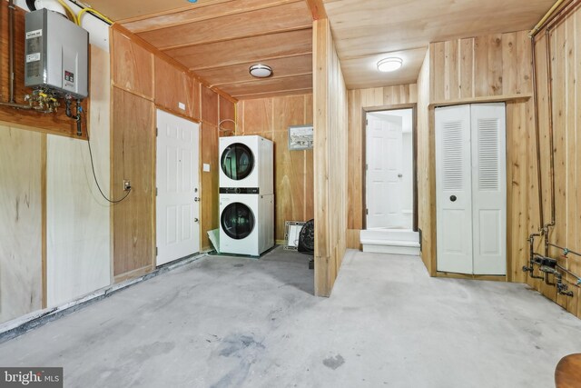 4 Virginia Rd, Glassboro, NJ 08028 - laundry area featuring stacked washing machine and dryer, water heater, and wooden walls