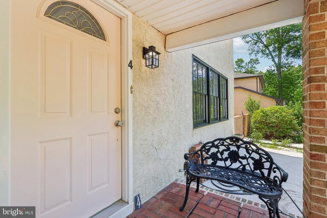 4 Virginia Rd, Glassboro, NJ 08028 - doorway to property with stucco siding and covered porch