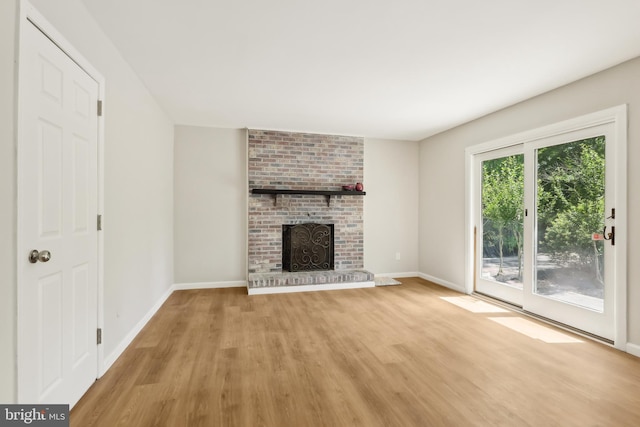 4 Virginia Rd, Glassboro, NJ 08028 - unfurnished living room with light wood-type flooring, baseboards, and a fireplace