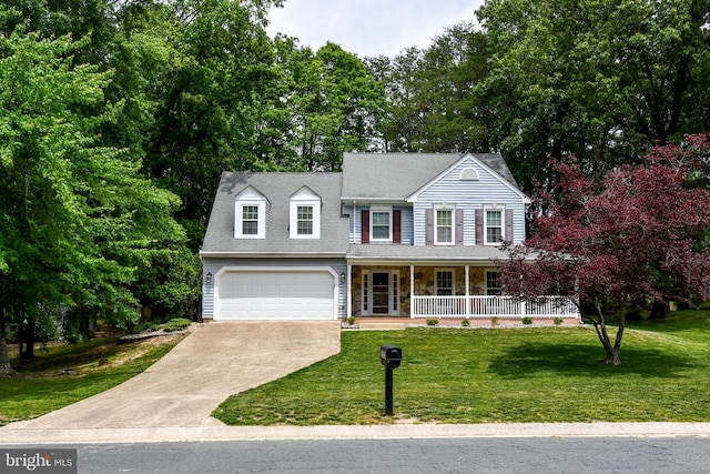 3505 Fox Ridge Rd, Waldorf, MD 20601 - view of front of property with covered porch, concrete driveway, an attached garage, a front yard, and view of scattered trees