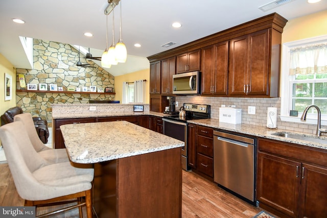 3505 Fox Ridge Rd, Waldorf, MD 20601 - kitchen with stainless steel appliances, a sink, wood finished floors, tasteful backsplash, and vaulted ceiling