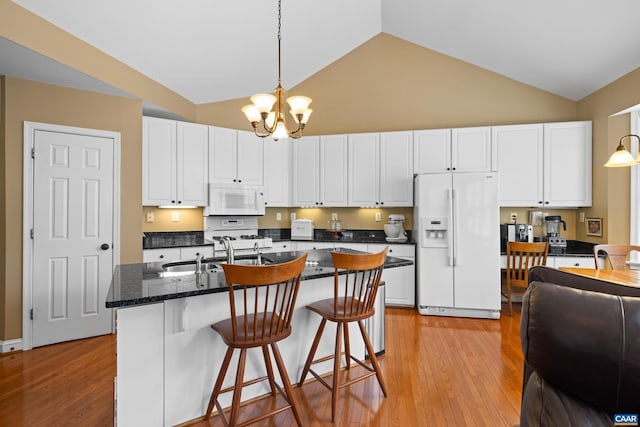 kitchen featuring a sink, high vaulted ceiling, a chandelier, white appliances, and white cabinetry