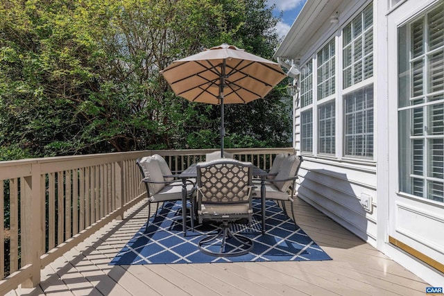 wooden deck featuring outdoor dining area
