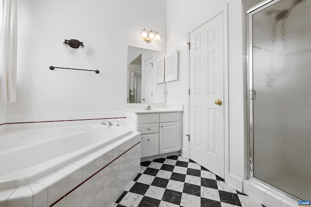 bathroom featuring vanity, a stall shower, tile patterned floors, and a garden tub